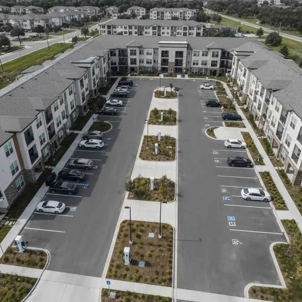 Aerial view of apartment parking with EV chargers installed along the center islands